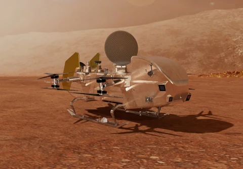 Artist’s concept of the Dragonfly rotorcraft resting on Titan’s orange-brown surface